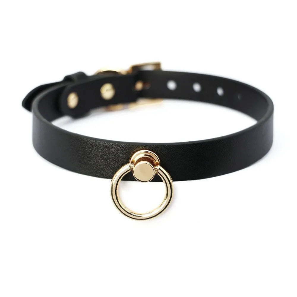 Genuine cowhide leather collar with metal fittings and a connected pull lead on a dark surface.