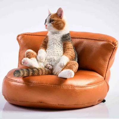 Small lazy cat model resting on a sofa, a resin car dashboard ornament decoration.