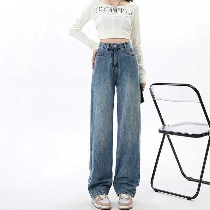 Women's retro blue high-waist wide leg jeans laid flat, showing the straight-leg trousers cut.