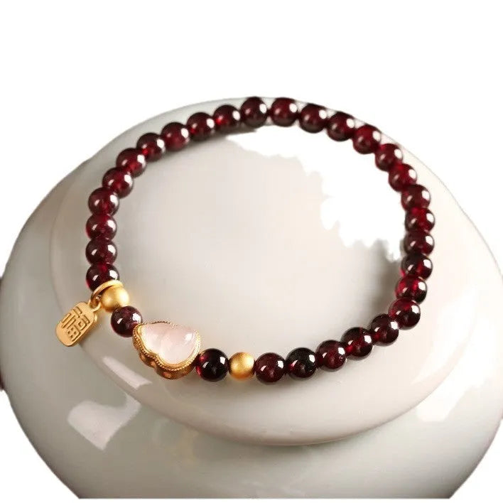 Chinese style gourd bracelet with imitation garnet stones and cultural motifs including Fu character design