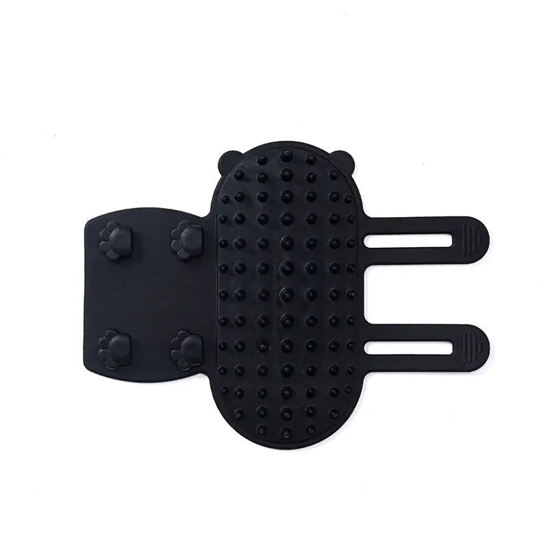 Black silicone cat grooming brush with comb teeth and an adjustable mounting strap.
