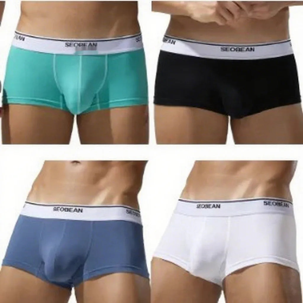 Men's cotton low waist boxer shorts in solid colours on a white background.