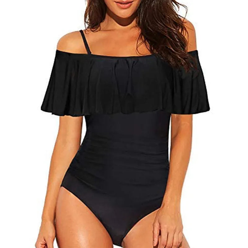 Black one-piece swimsuit with cut-out design and ruffled straps on a mannequin.