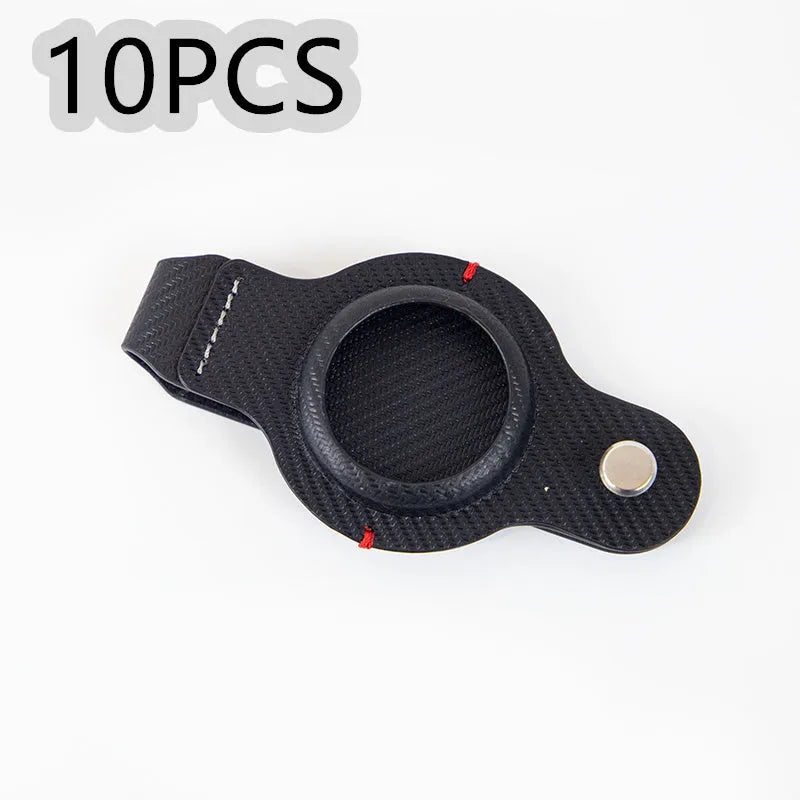 Black PU leather AirTag keychain holder with metal key ring on a set of keys
