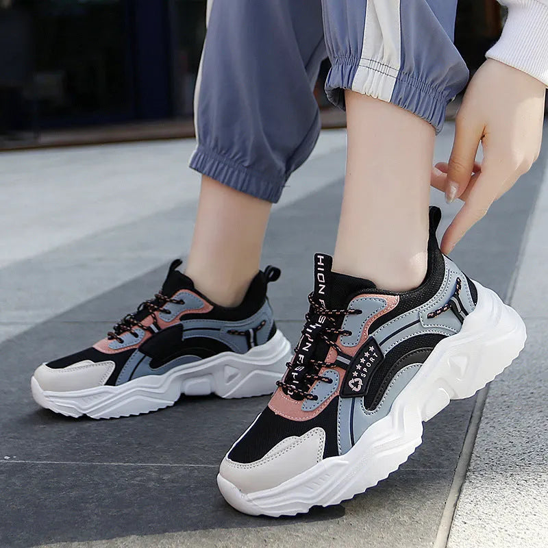 White women's thick-soled casual trainers with mesh upper and buckle detail