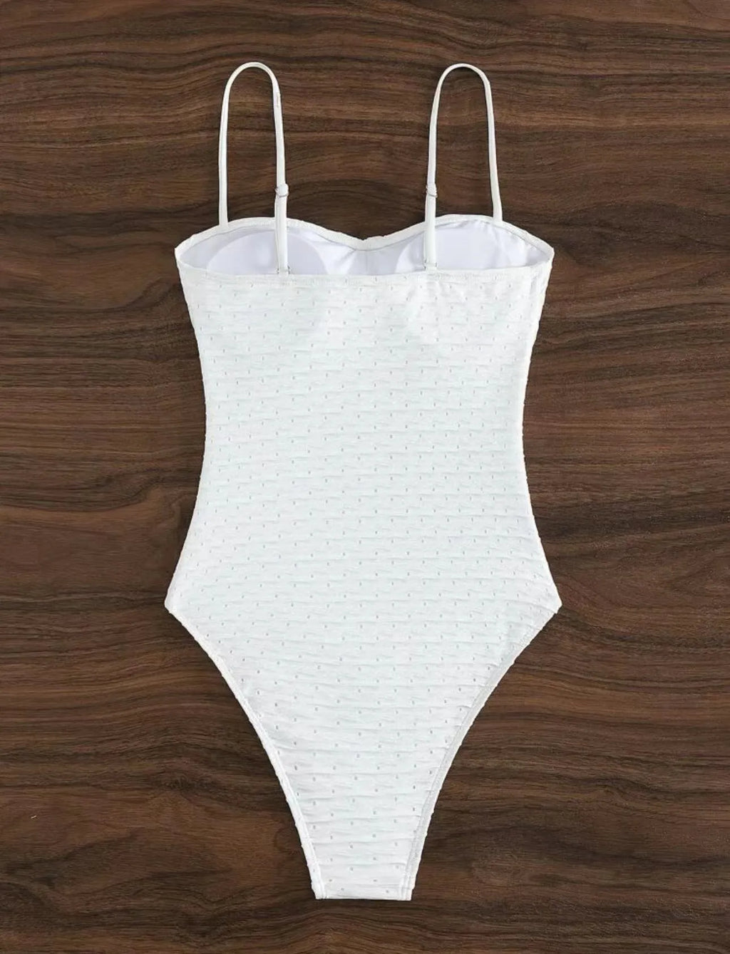 White women's one-piece swimsuit with a sling back and briefs-style cut.