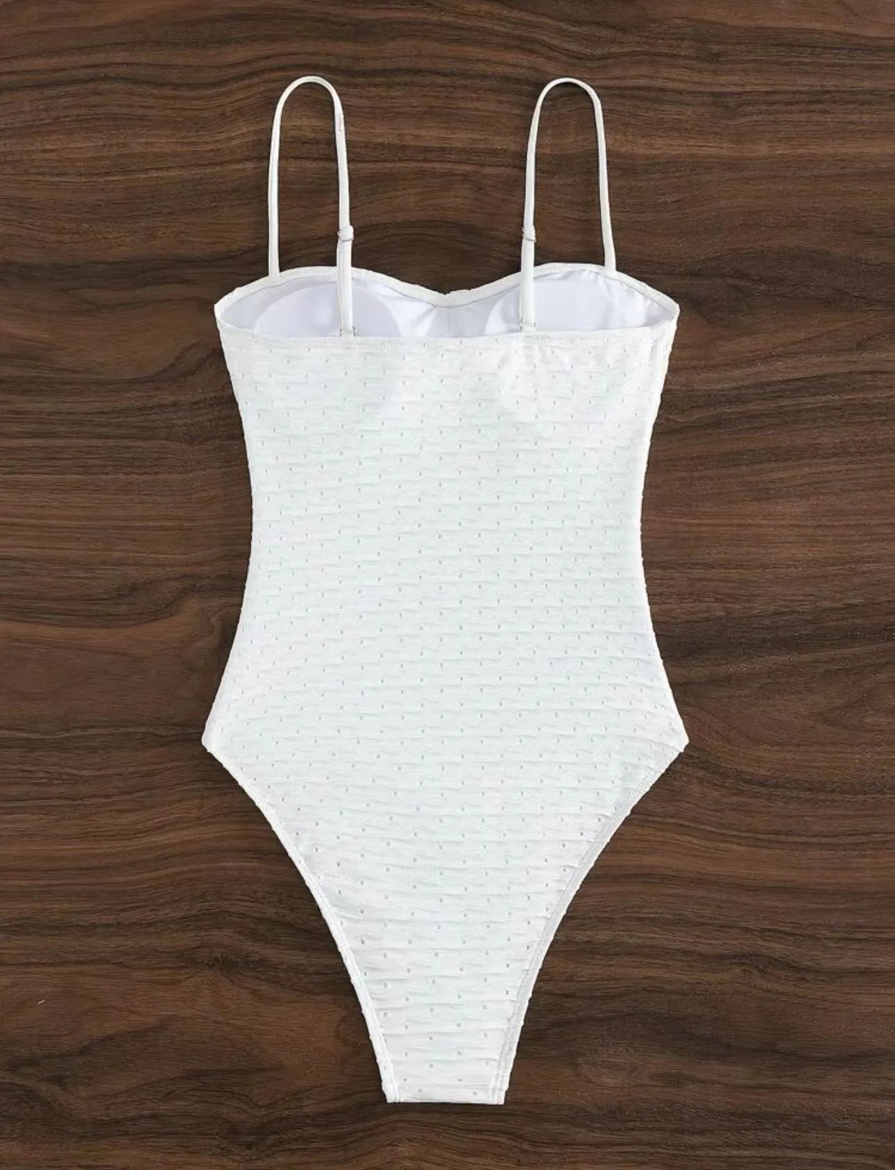 White women's one-piece swimsuit with a sling back and briefs-style cut.