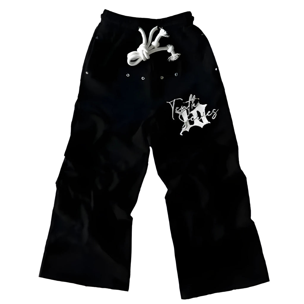 Black fleece embroidered printed loose fit pullover sweatpants on a model