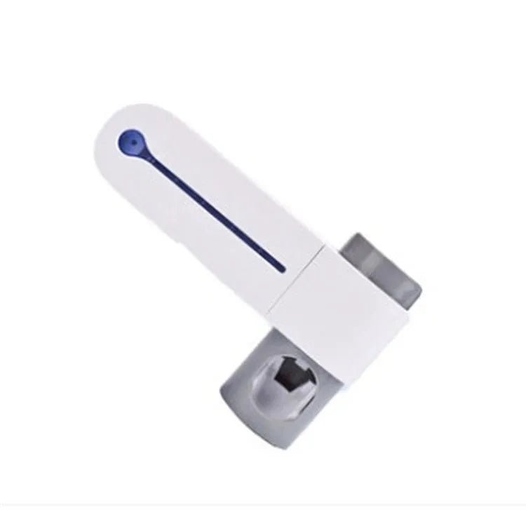 White 3-in-1 toothbrush holder with UV steriliser and toothpaste dispenser, wall-mounted on a bathroom tile