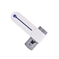 White 3-in-1 toothbrush holder with UV steriliser and toothpaste dispenser, wall-mounted on a bathroom tile