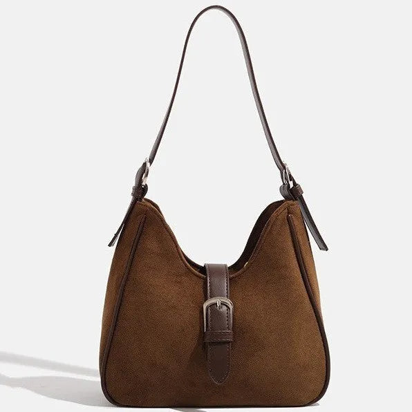 Retro suede leather underarm shoulder bag in brown with double connector straps on a white background
