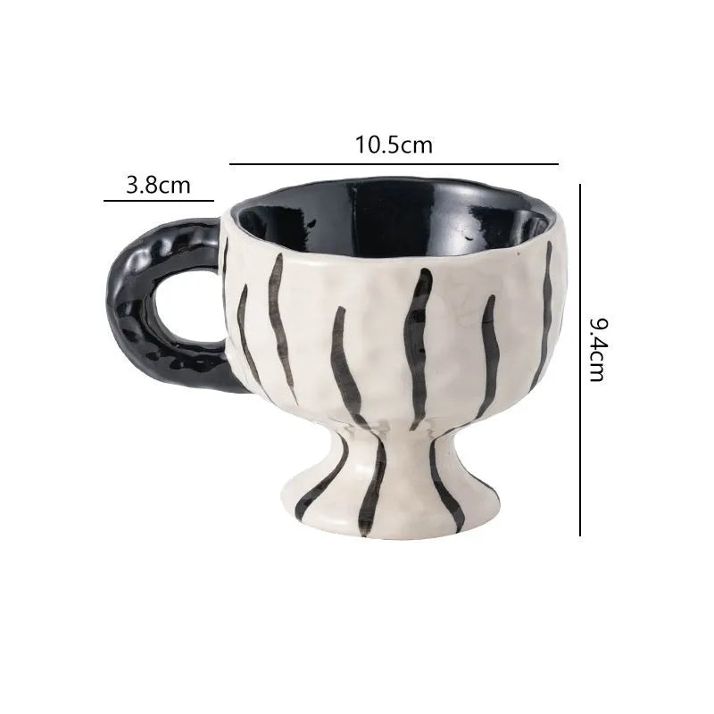 Hand-pinched irregular ceramic mug showing solid colour and unique shape