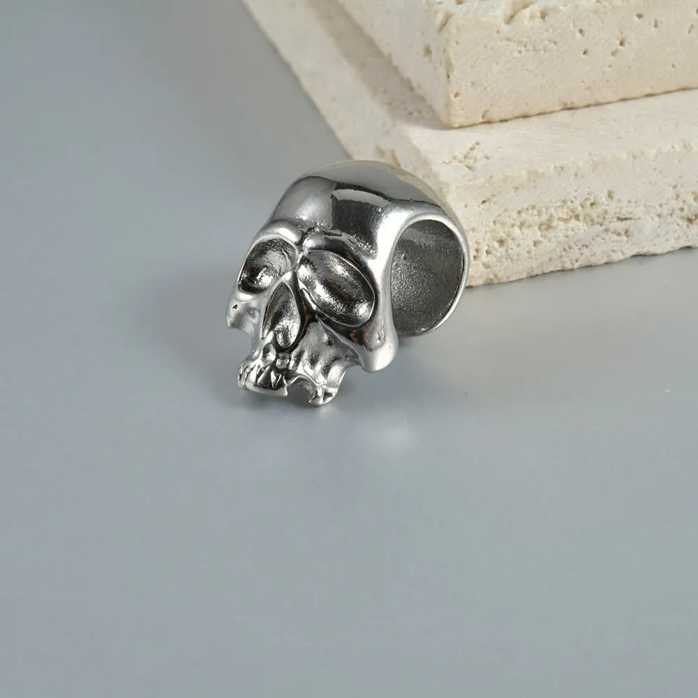 Stainless steel hollow skull Buddha earring in a geometry shape, shown in one of four colour options.