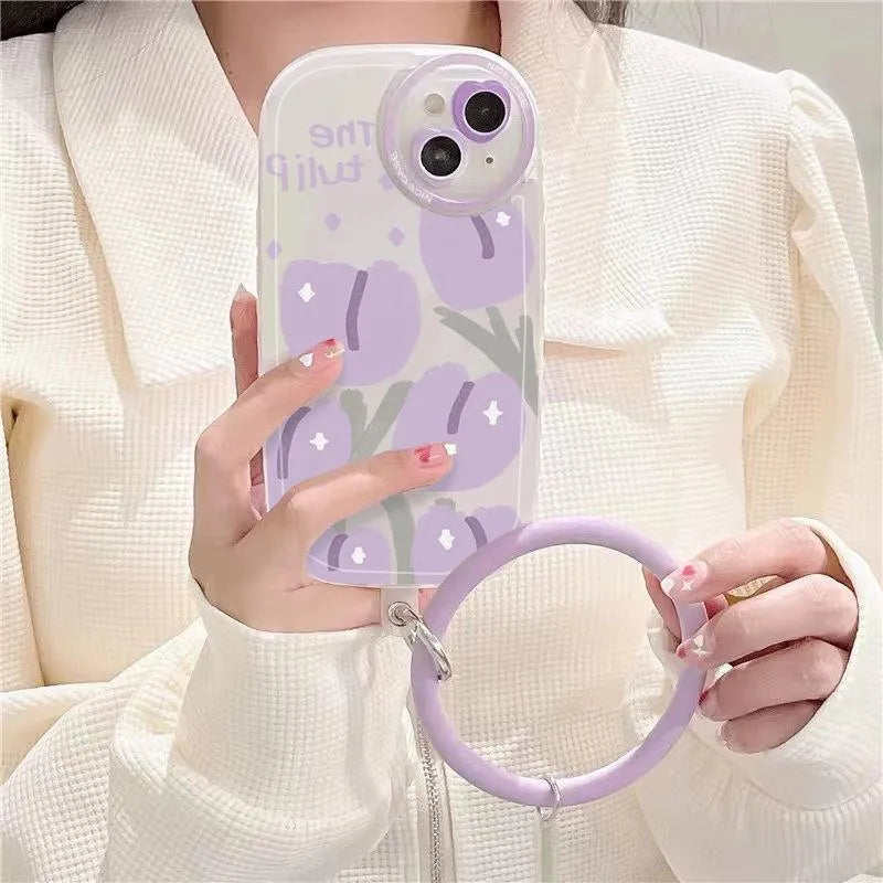 Purple transparent iPhone case with ring holder and tulip heart pattern, includes matching wrist strap