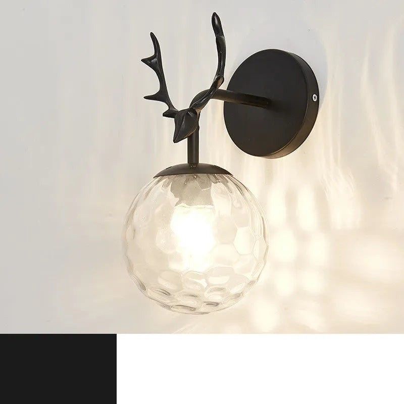 Round glass Nordic wall lamp with golden water pattern finish on a white wall.