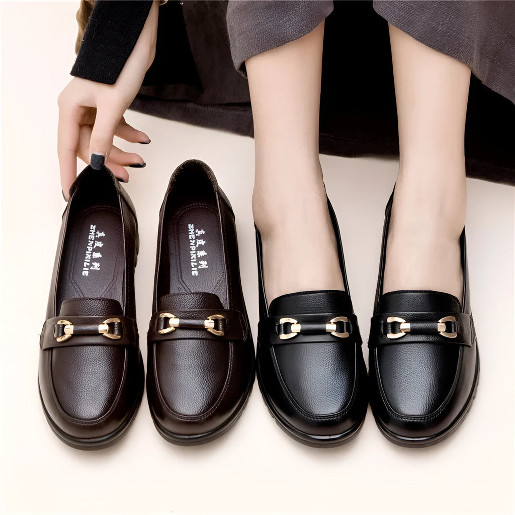 Black soft-leather casual pumps with round toe, low flat heel, and rubber sole.