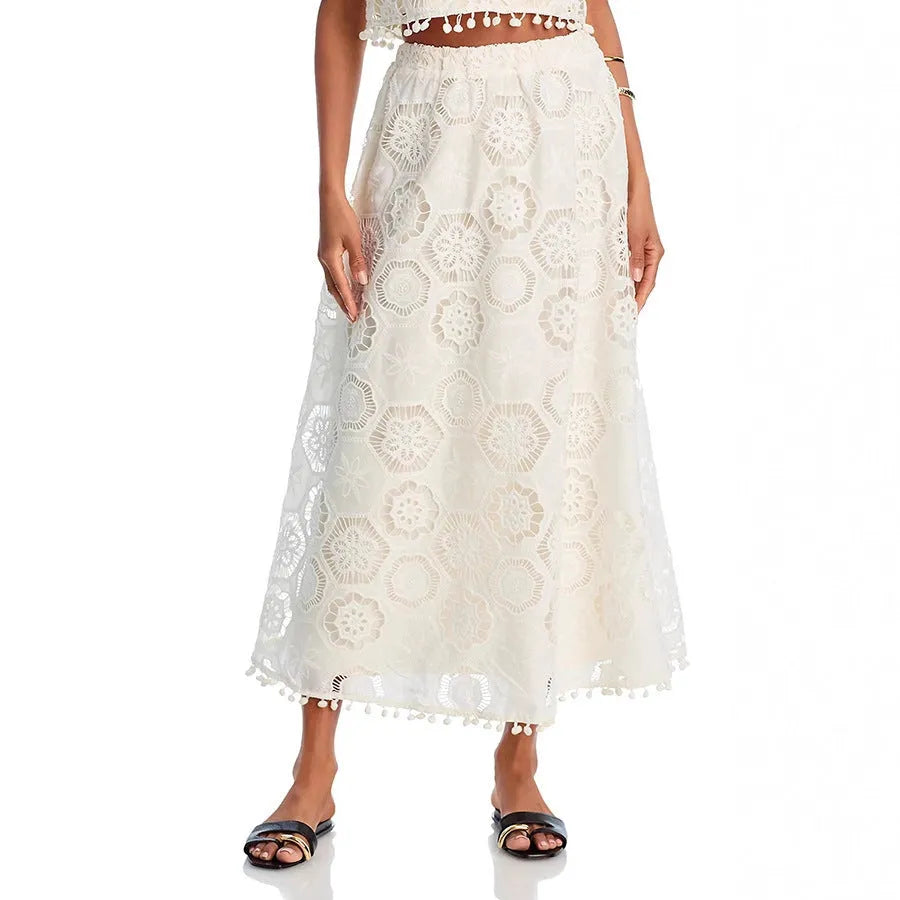 White women's two-piece suit with sleeveless top, long embroidered skirt, retro style.