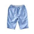 Men's loose-fitting linen capri trousers in a straight-leg style on a neutral background.