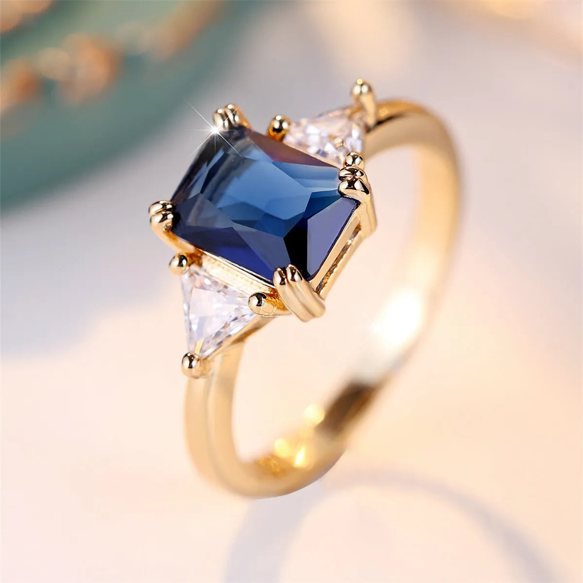 Rectangular gold sapphire blue copper women's ring showing geometric band shape