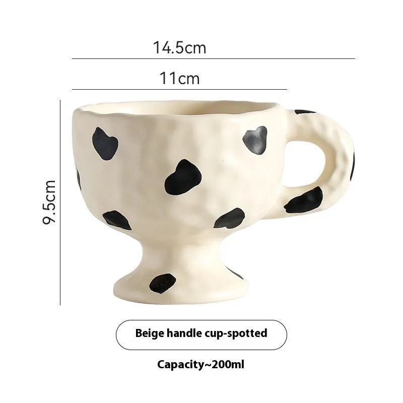 Hand-pinched irregular ceramic mug showing solid colour and unique shape