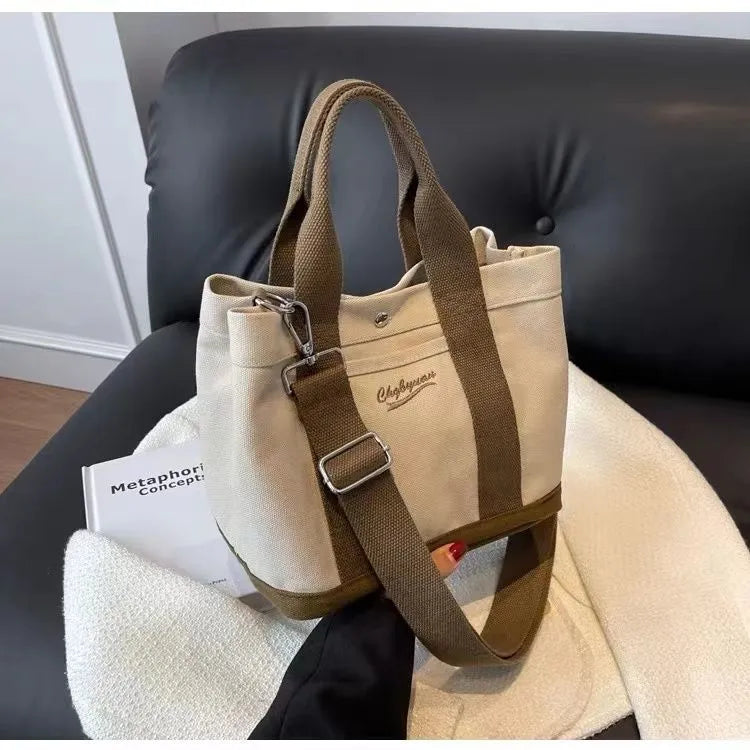 Beige soft canvas bucket-shaped messenger bag with sandwich pockets and three shoulder straps