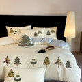 Pure cotton four-piece bed set with embroidered Christmas tree pattern in cream blue and green colours.
