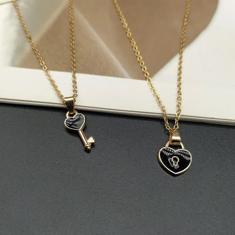 Small alloy lock and key pendant necklace set in black with 40cm chain on white background