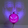 Plastic pumpkin-shaped lamp glowing with either purple or yellow light, measuring 22cm tall.