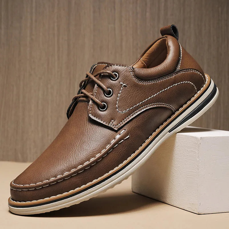 Men's black genuine leather casual lace-up shoes with round toe and rubber sole on a white background.