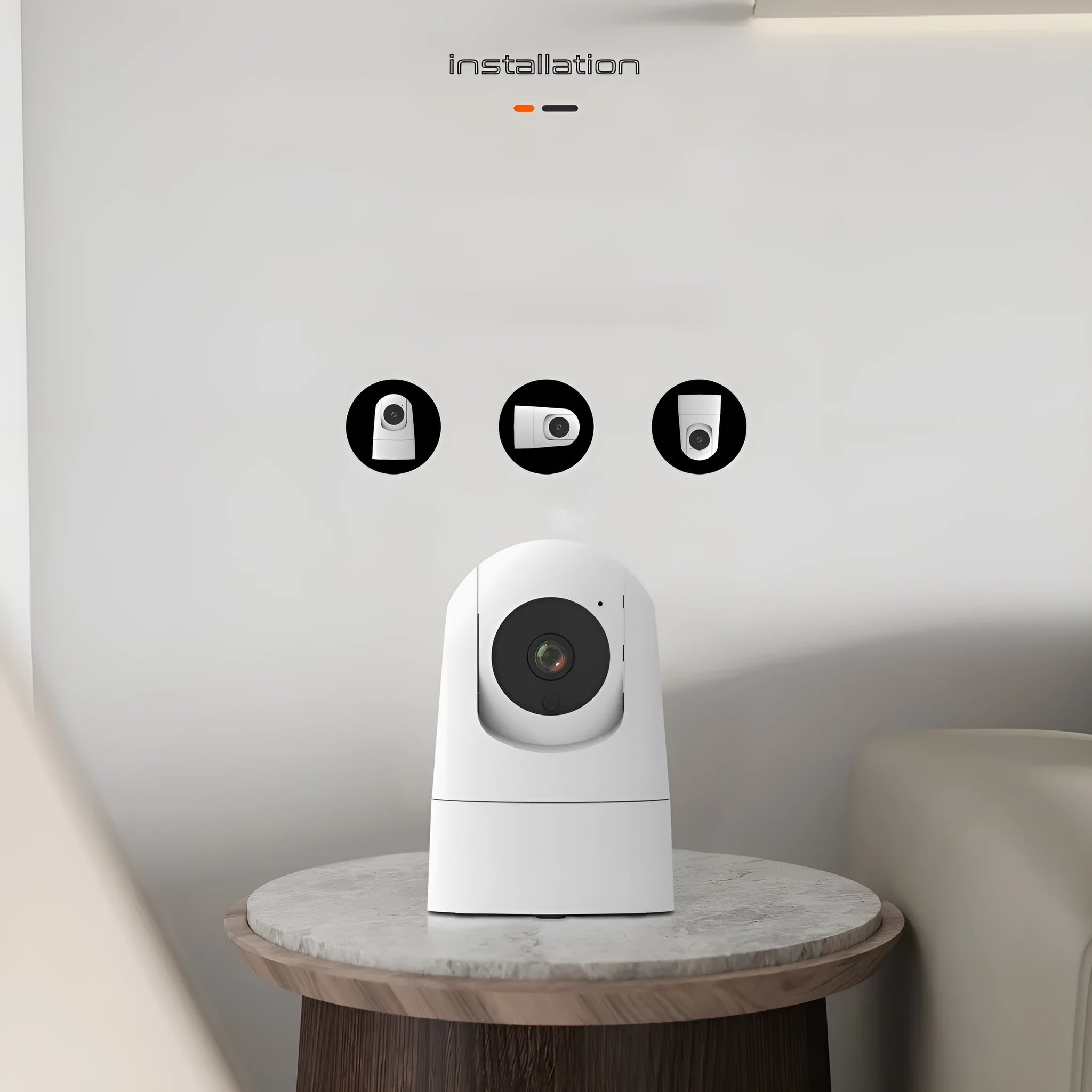 White indoor pan-tilt security camera with wide-angle lens on a desk.