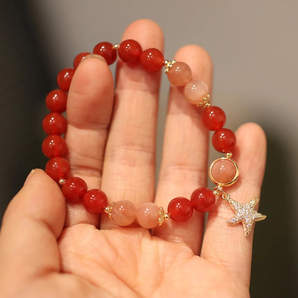 Handmade red agate and sunstone bracelet with carved xiangyun ethnic motifs, 8mm bead diameter