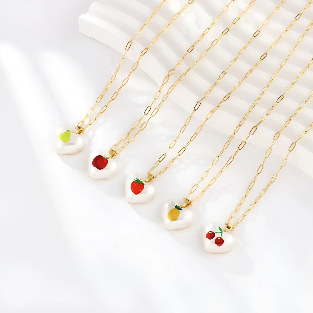 Heart-shaped necklace with geometric chain and a detailed fruit pendant charm, adjustable from 21cm to 50cm.