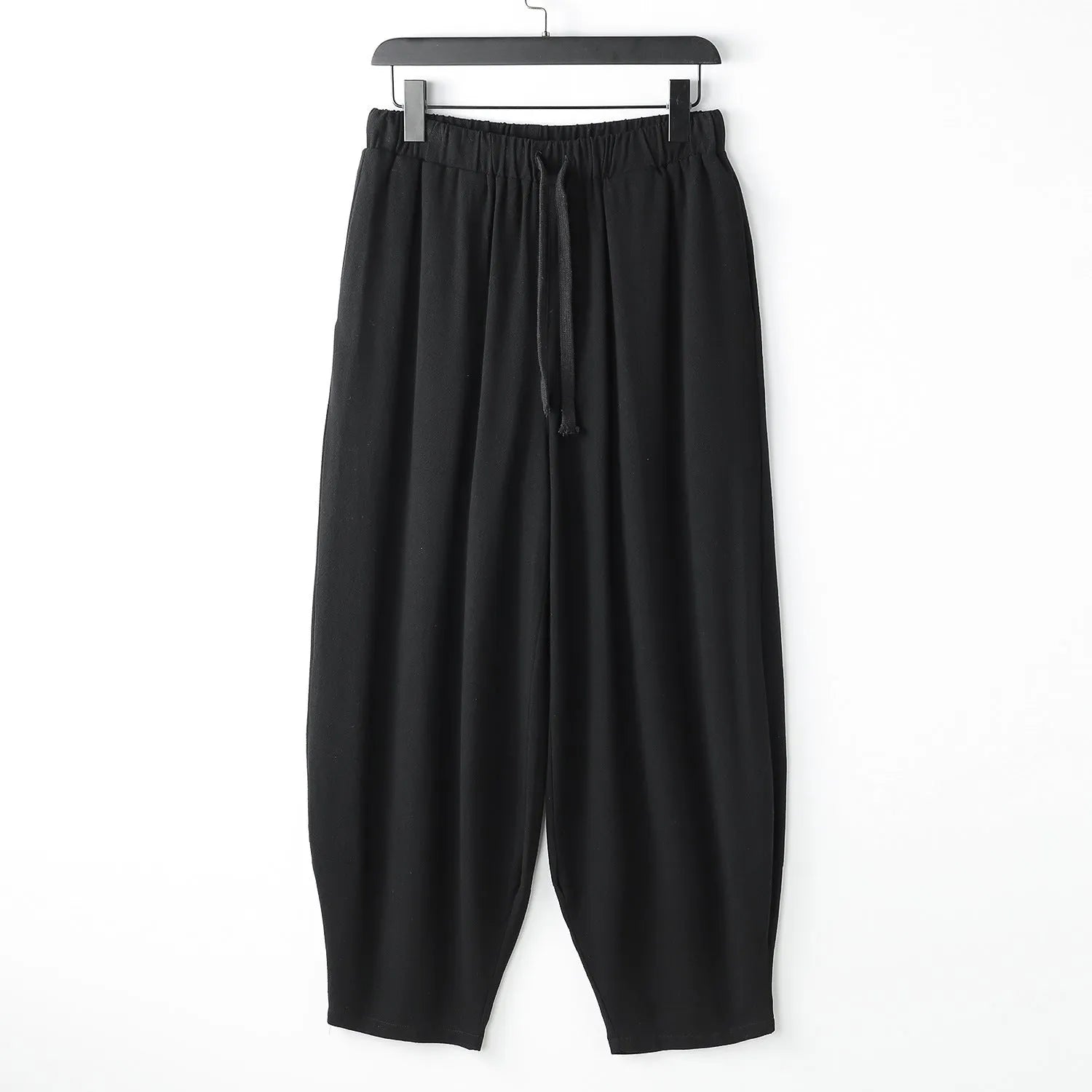 Men's linen harem pants with ankle ties in tapered loose fit on larger model