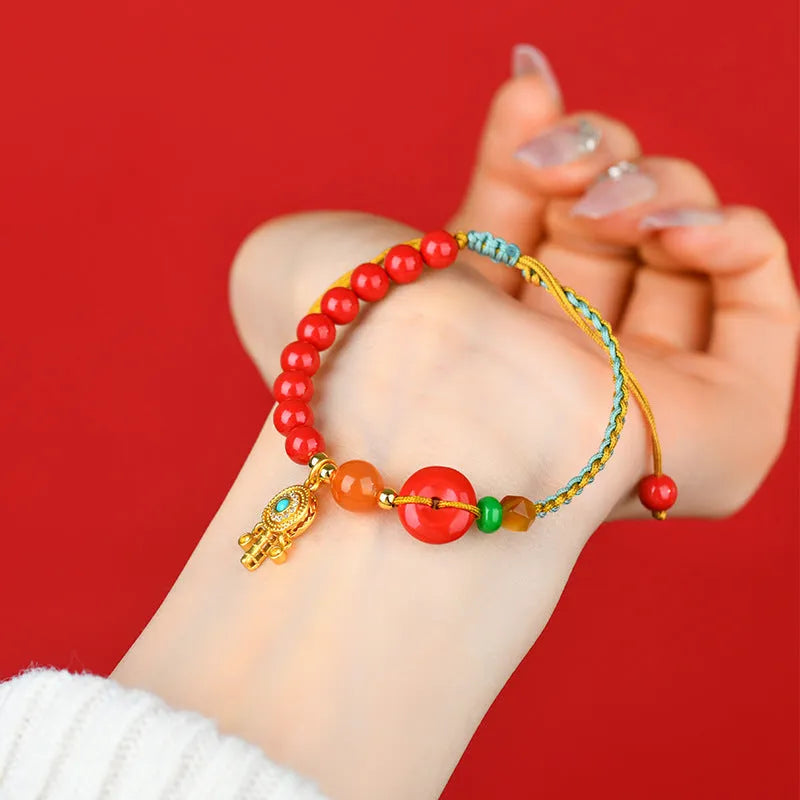 Hand-woven cinnabar peace buckle bracelet in emperor red sand colour with geometric pattern