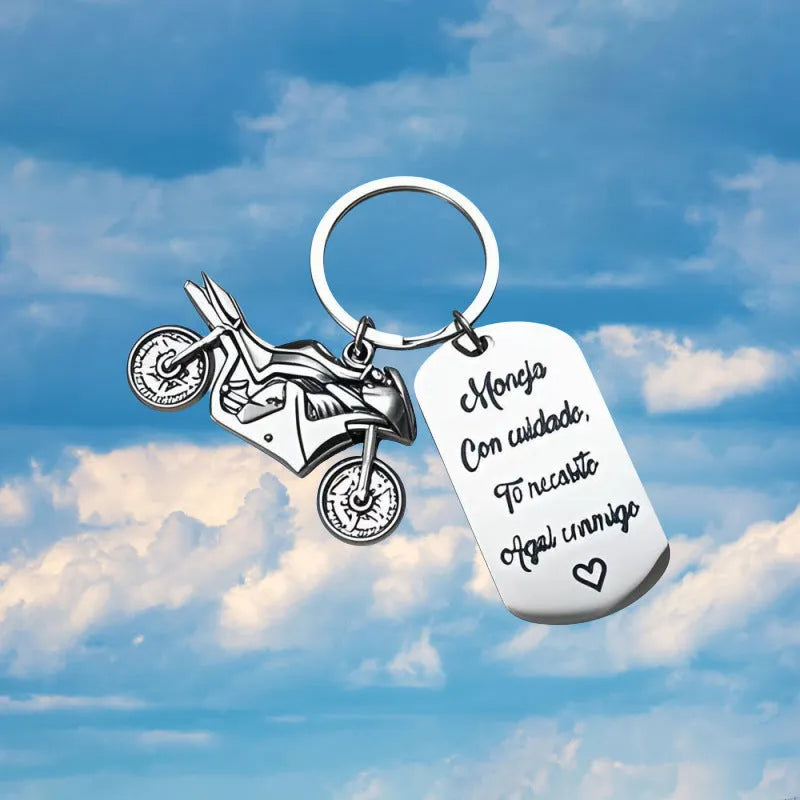 Stainless steel motorcycle-themed keychain on a velvet flannel bag