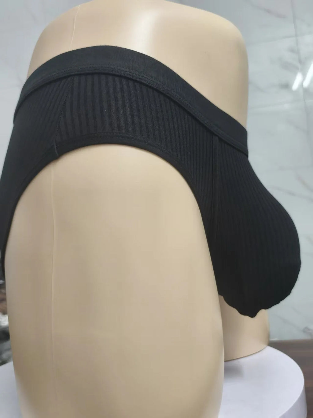Men's black U-shaped underwear with triangle pouch design showing knitted viscose fabric texture