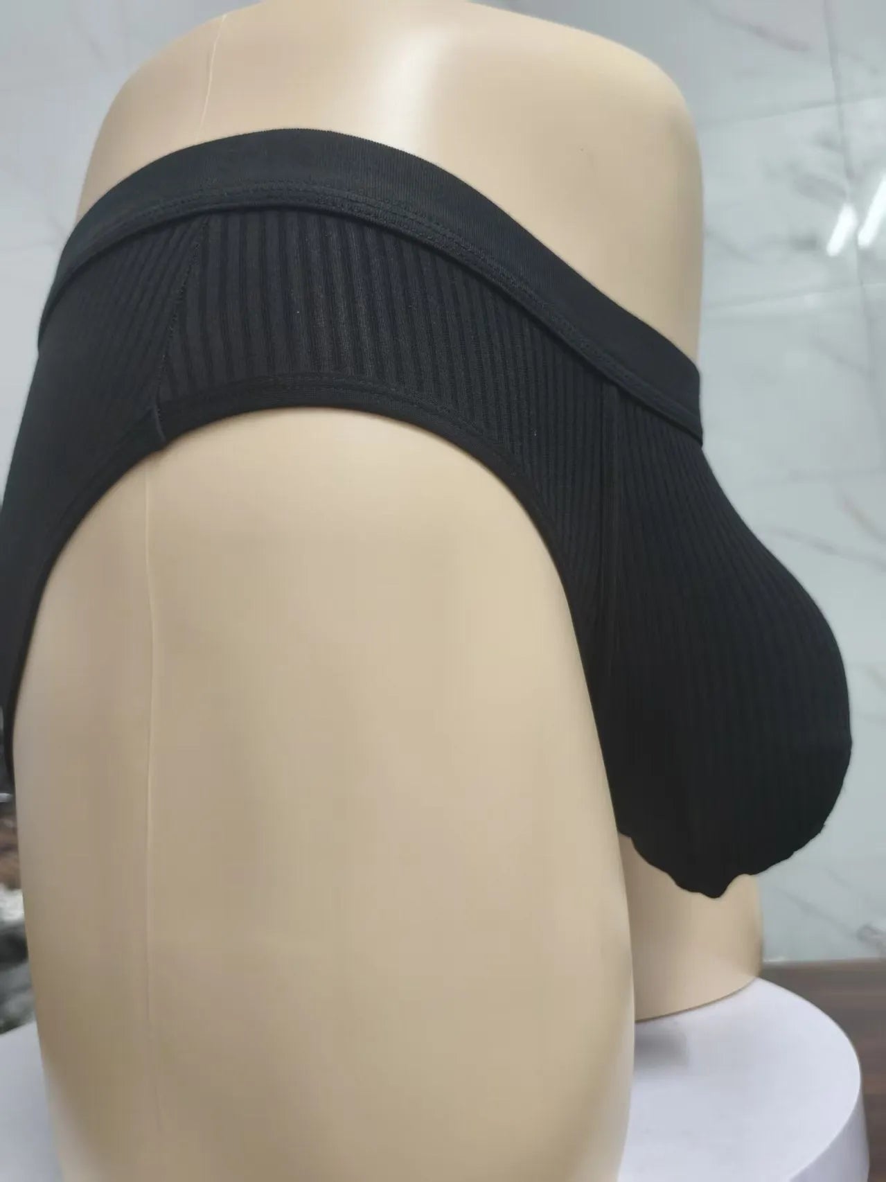 Men's black U-shaped underwear with triangle pouch design showing knitted viscose fabric texture