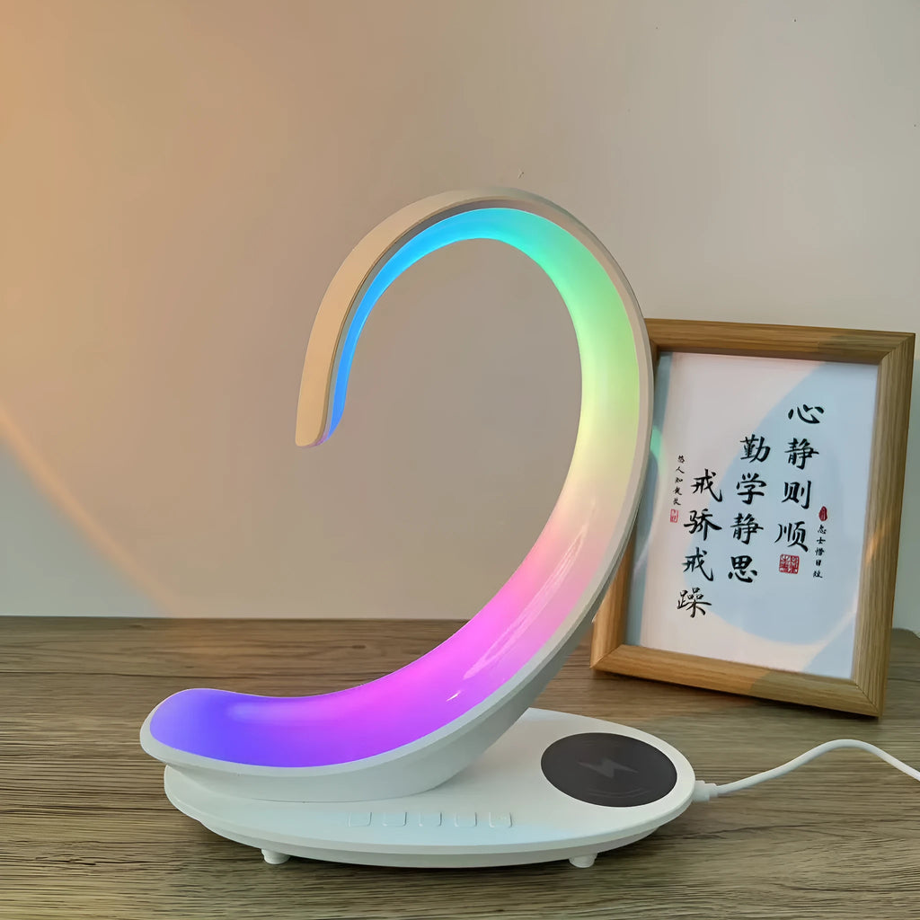 Multi-functional white swan desktop light with wireless charger, Bluetooth speaker, and colourful atmosphere light on a desk