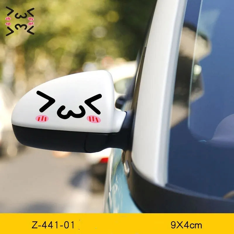 Pair of reflective cartoon eye car stickers on a vehicle rearview mirror.