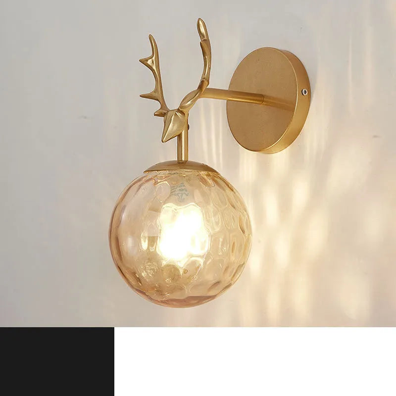 Round glass Nordic wall lamp with golden water pattern finish on a white wall.