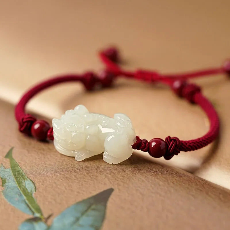 Traditional Chinese Hetian jade bracelet with black and red braided ropes and jade beads on elastic cord