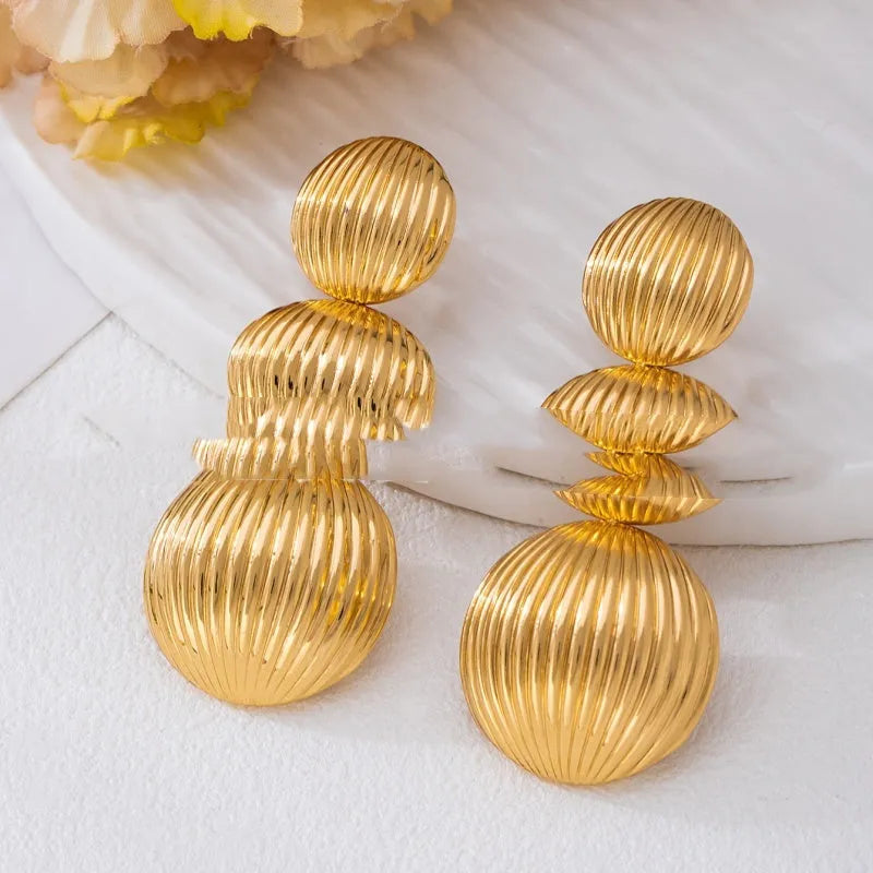 Retro women's polka dot metal bead drop earrings in frosted gold finish on a neutral background