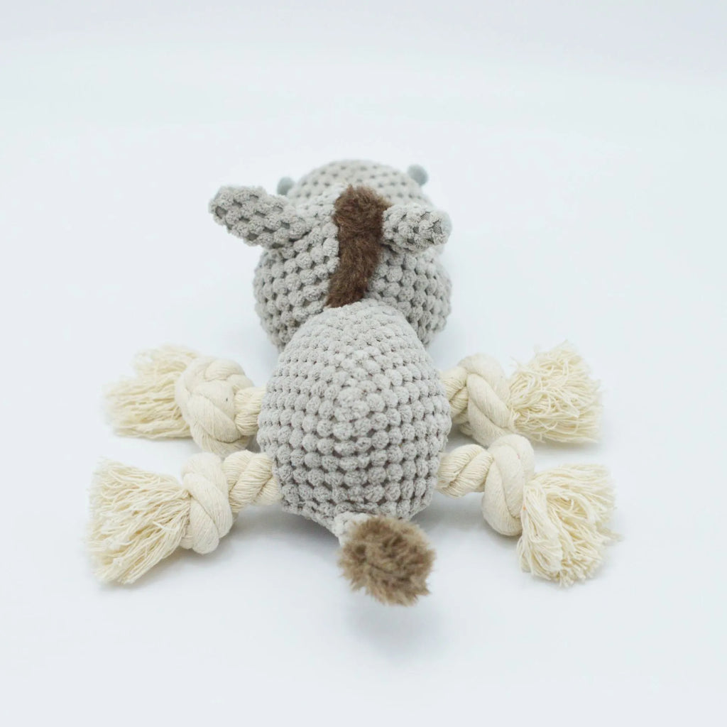 Grey plush donkey dog toy with creaking sound, showing size against a hand.