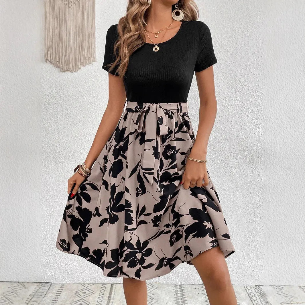 Women's khaki floral print A-line dress with lace-up front and shoulder strap details.