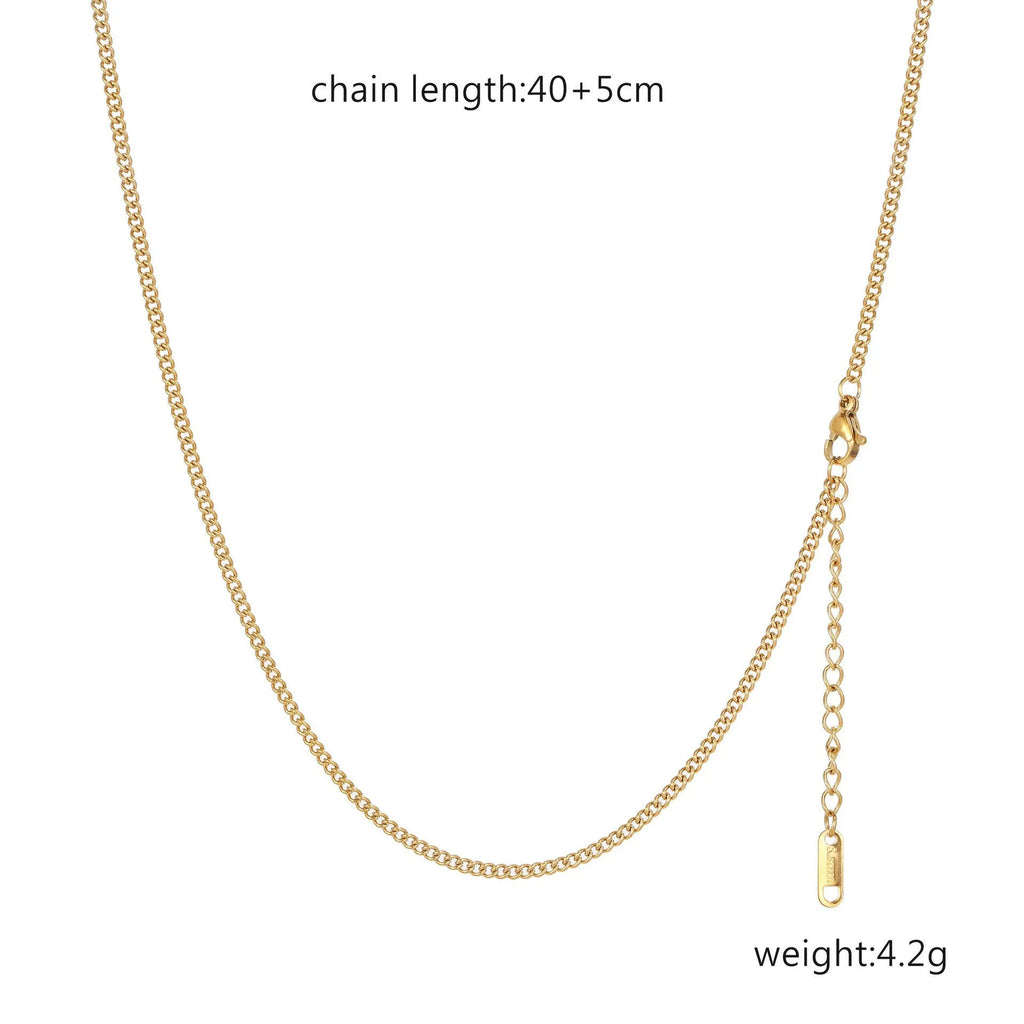 Women's stainless steel necklace with 18K gold hollow round pendant and O-link chain on neutral background