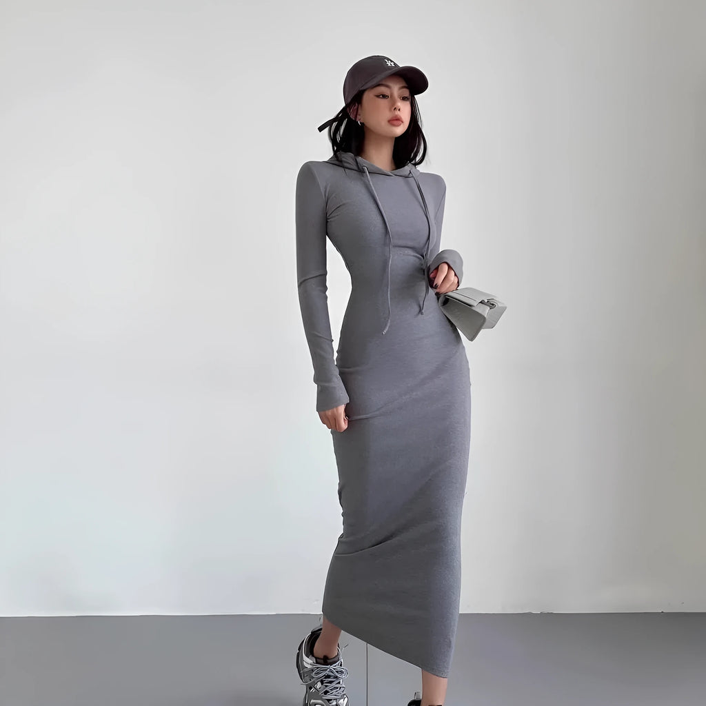 A woman's light grey hooded sheath dress with long sleeves, high waist, and over-the-knee length.