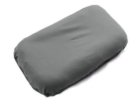 Cotton portable baby nest crib for newborns, beige colour, shown on a bed.
