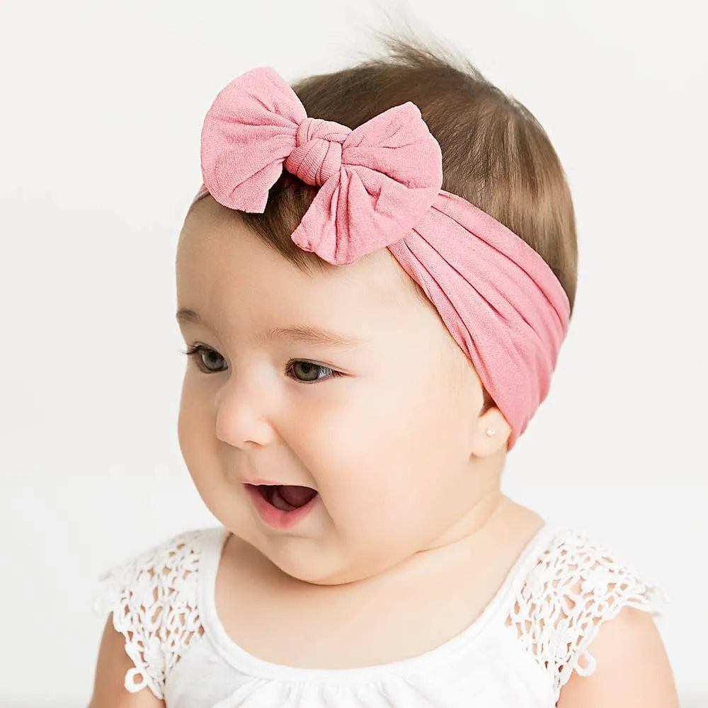 Super stretchy soft knot headband with hair bow for baby girls in one of 22 colours
