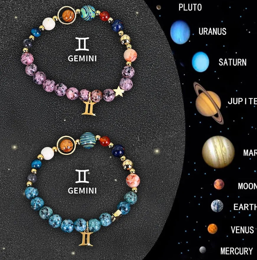 Two natural stone beaded bracelets with zodiac charms on a table.
