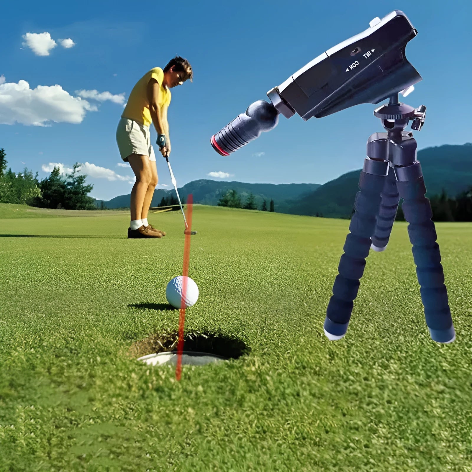 Golf putter laser aiming instrument on a putting green, showing laser alignment line.